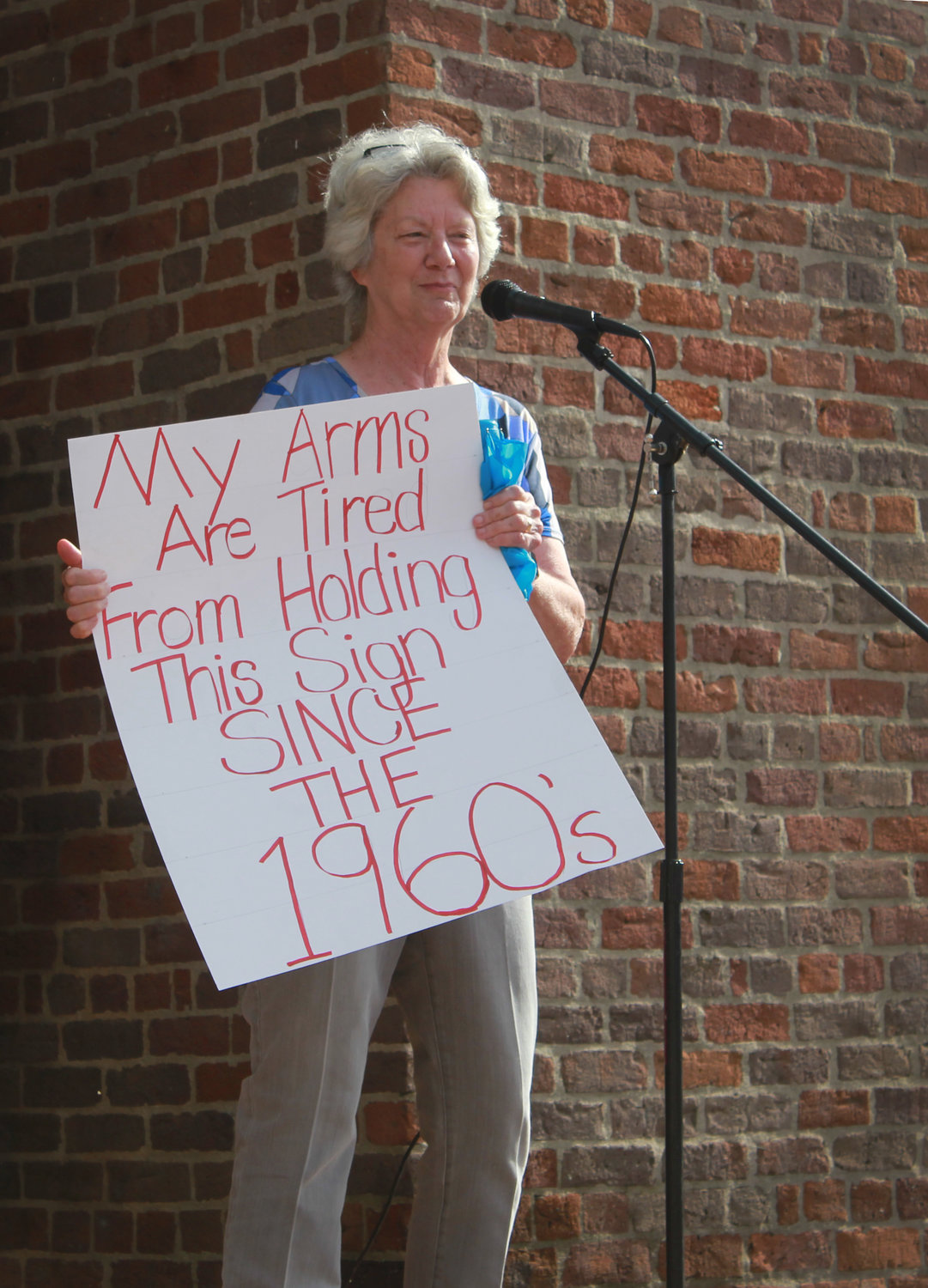 Pittsboro Mayor Cindy Perry holds up her sign as she speaks to the crowd during the abortion and women’s righs protest on Monday at the HIstoric Courthouse in Pittsboro. Perry spoke to how the overturning of Roe v. Wade will have a domino effect on all women’s rights.